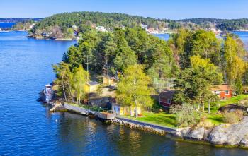 Rural Swedish landscape, coastal villages with wooden houses and barns in sunny summer day