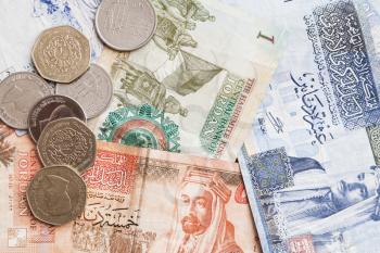 Jordanian dinars banknotes and piastres coins close-up, background photo