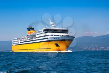Big yellow passenger ferry goes on the Mediterranean Sea near Corsica island, France