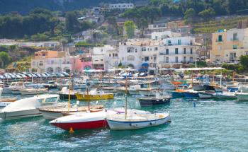 Port of Capri island, Italy. Colorful houses and moored pleasure motorboats