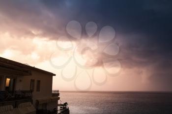 Coastal morning landscape with cloudy sky and living house. Ischia island, Italy