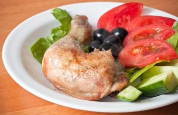 Roast chicken leg with salad and fresh vegetables
