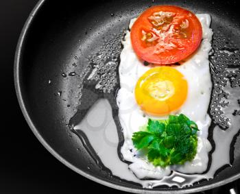 Original breakfast theme. Fried egg with tomato and greens in shape of Traffic Light in a frying pan
