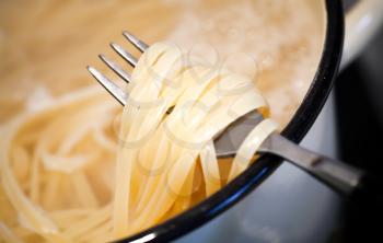 Noodles in the pan with fork
