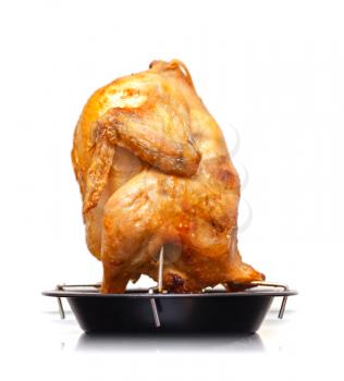 Whole grilled chicken on black metal pan isolated on white background
