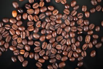 Fresh roasted coffee beans on black background