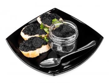 Sandwiches with black caviar and spoon on dark plate