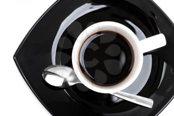 Coffee in white cup on black saucer,  top view isolated on white