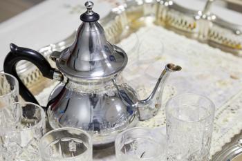 Arabic tea theme. Metal teapot with glasses