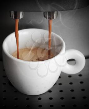 Espresso preparing, white ceramic cup in coffee machine