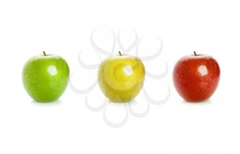 Closeup studio photo of green, yellow and red apples isolated on white background with soft shadow and reflection. Traffic lights color scheme concept