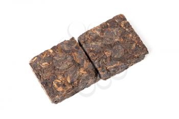 Two small pressing briquette of black Chinese Shu Pu-erh tea isolated on white background, top view