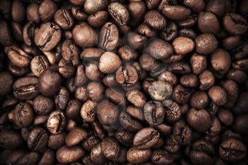Closeup photo background with dark roasted coffee beans