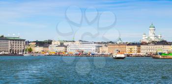 Helsinki, Finland - June 13, 2015: Summer Helsinki cityscape. Central quay, building facades, walking people and dome of the main city cathedral