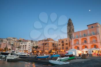 Port with moored boats and pleasure yachts. Night cityscape of Gaeta town, Italy