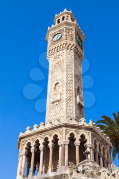 Old clock tower under blue sky, it was built in 1901 and accepted as the official symbol of Izmir City, Turkey