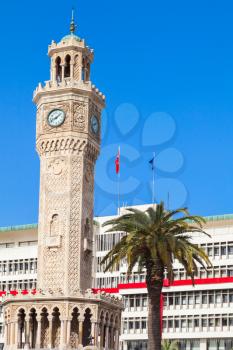 Historical clock tower under blue sky, it was built in 1901 and accepted as the official symbol of Izmir City, Turkey