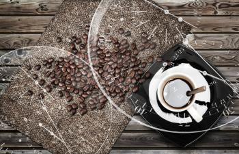 Cup of espresso coffee with beans and canvas on weathered wooden table. Coffee break metaphor illustration