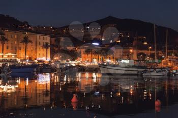 Pleasure yachts and fishing boats moored in old port of Ajaccio, the capital of Corsica island, France. Night photo
