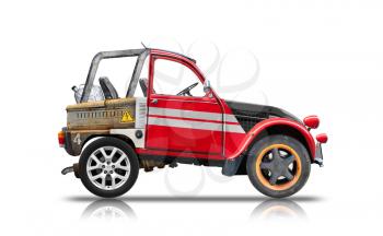 Small buggy car assembled from spare parts. Side view isolated on white background with reflection and soft shadow. Photo collage, unique design