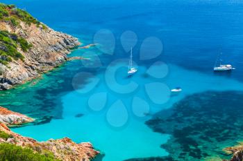 Corsica, French island in Mediterranean Sea. Coastal summer landscape, yachts moored in azure bay