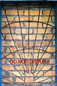 Do not disturb label on the brick-encased window with railings