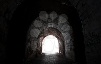Glowing end of dark abandoned tunnel