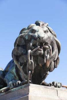 Ruse, Bulgaria - September 29, 2014: Outdoor bronze statue of lion breaking thick chain