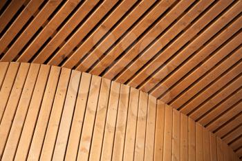 Abstract architecture background with wooden planking curved construction. Scandinavian natural design example.