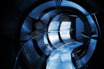 Abstract underground industrial sewerage. Dark blue metal tunnel interior