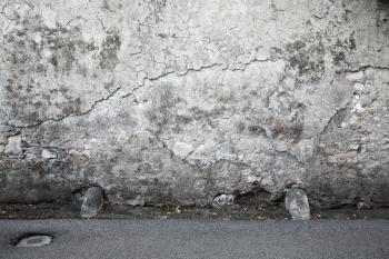 Empty Interior background texture with dark ancient gray stone wall and asphalt road