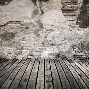 Empty abstract interior background with damaged brick wall and dark wooden floor