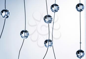 Abstract blue monochrome background with glass spherical design elements of modern chandelier