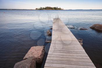 Finnish Saimaa lake landscape with wooden pier for swimming