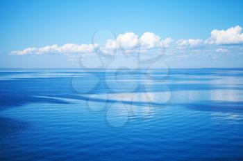 Seascape with blue water and cloudy sky