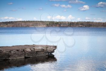 Still lake coastal landscape with old stone pier, Monrepo park, Vyborg Bay, Russia
