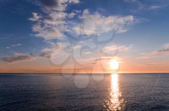 Early morning on the sea. Landscape with rising Sun and crossing waves