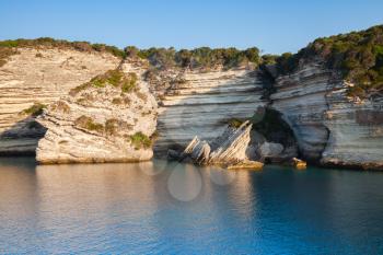 Bay of Bonifacio, coastal rocks in morning sunlight. Mountainous Mediterranean island Corsica, Corse-du-Sud, France