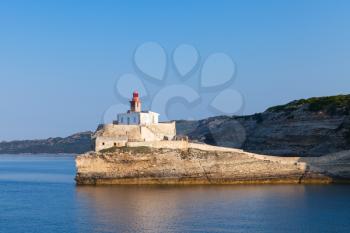 Madonetta lighthouse tower on coastal rock. Entrance to Bonifacio port. Mountainous Mediterranean island Corsica, Corse-du-Sud, France