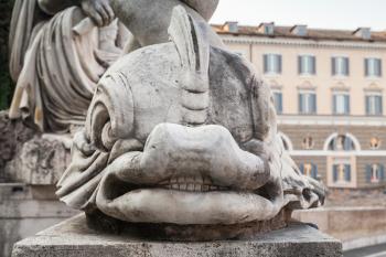 Ancient sculpture with fish on the Piazza del Popolo square, old city center of Rome, Italy