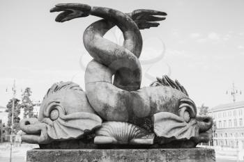 Ancient fish sculpture on the Fontana del Nettuno fountain, Piazza del Popolo square, old city center of Rome, Italy. Monochrome photo