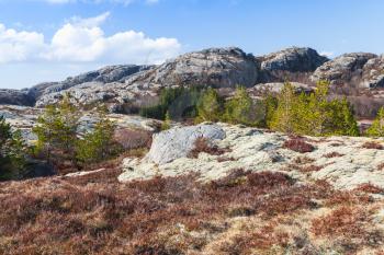 Norwegian mountain landscape with rocks under blue cloudy sky