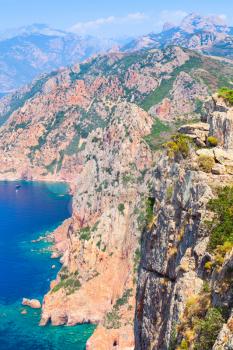 Rocks and sea in summer time. Vertical landscape of French mountainous Mediterranean island Corsica. Corse-du-Sud, Piana region