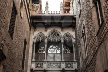 Ancient arch and balcony over Carrer del Bisbe, Gothic Quarter, Barcelona
