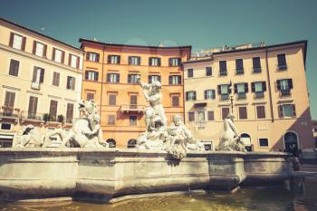 Piazza Navona, Neptune Fountain in summer day. Rome, Italy. Vintage stylized photo with tonal correction photo filter effect, retro style