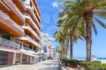 Modern buildings on coastal street of Calafell resort town in sunny summer day. Tarragona region, Catalonia, Spain
