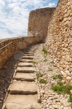 Old stone stairs go up to the ancient fortress of Calafell town, Spain