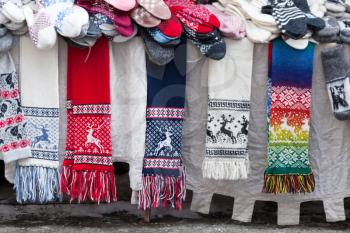 TALLINN, ESTONIA - MARCH 2013: Woolen scarves, socks and other souvenirs lie on the street counter on March 12, 2013. This is a traditional Estonian handcraft souvenirs