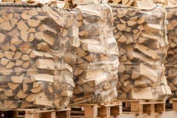 Packed stacks of fire wood laying on palettes in the market