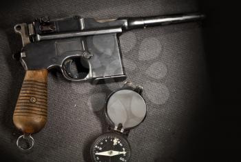 Old German pistol with compass on the table